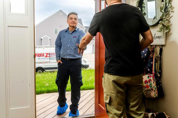 Freezone technician greets customer at their door